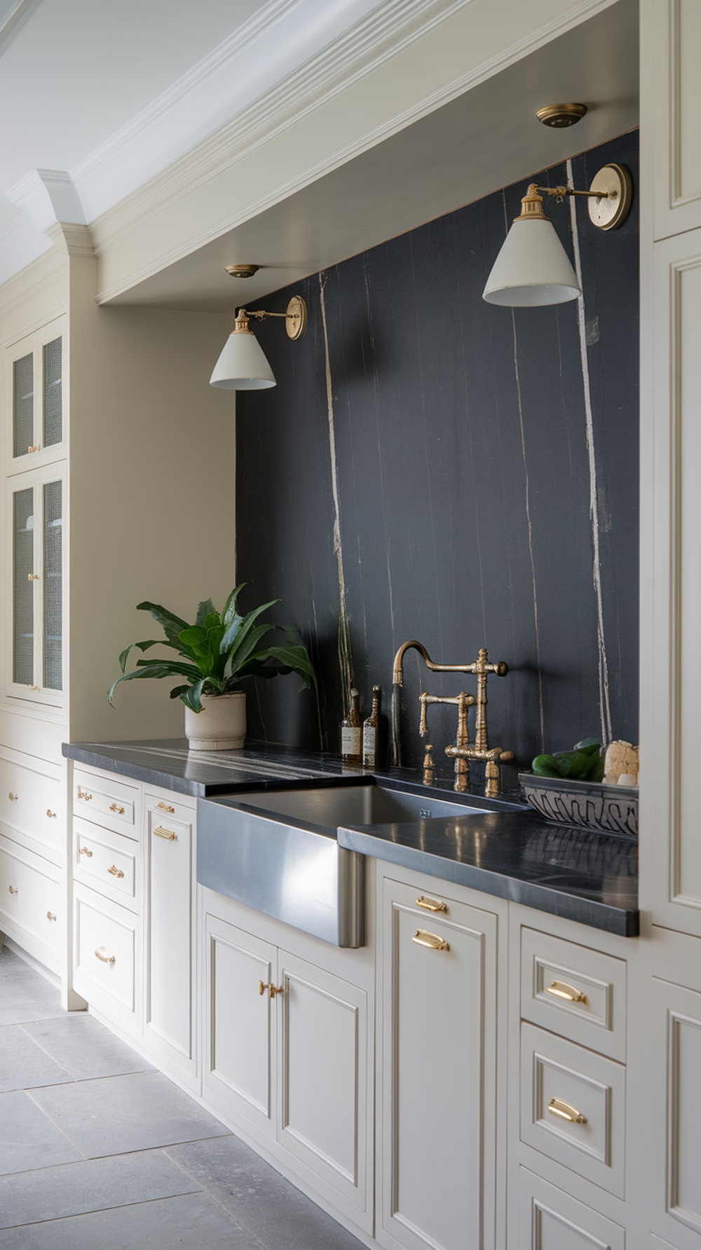 A modern kitchen featuring a sophisticated onyx backsplash with gold fixtures and cabinetry.